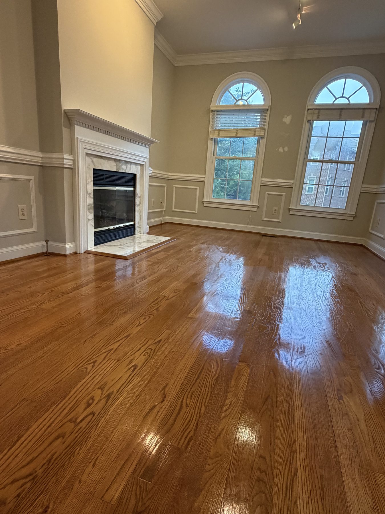 Client-provided photo of an empty living room in a move-in or move-out project