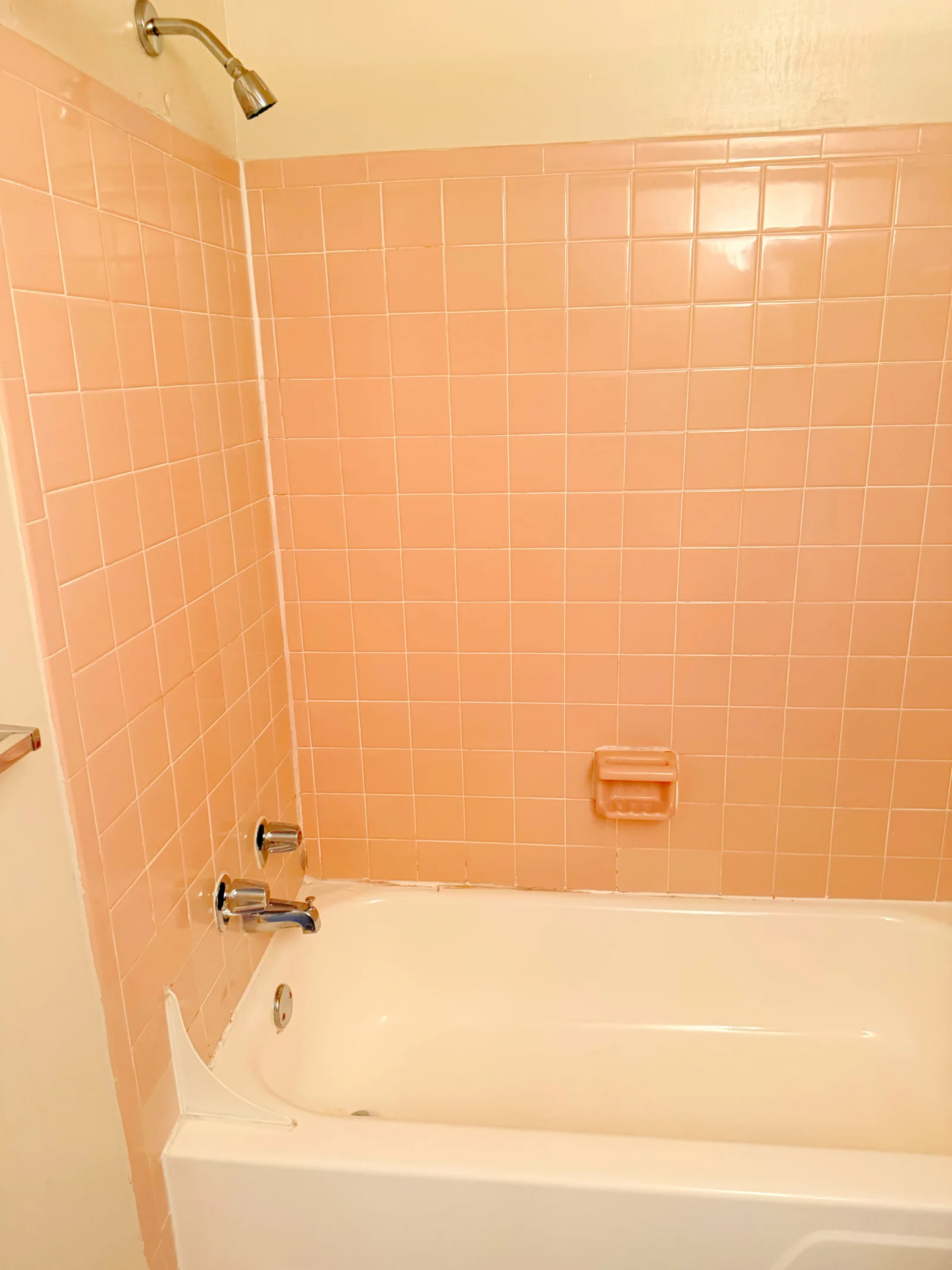 Client-provided after photo showing clean pink tile and bathtub
