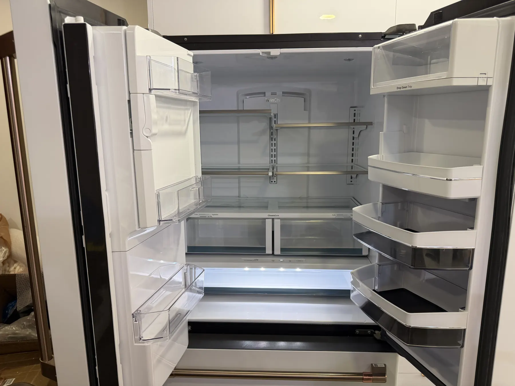 Client-provided after photo showing the refrigerator interior cleaned and empty