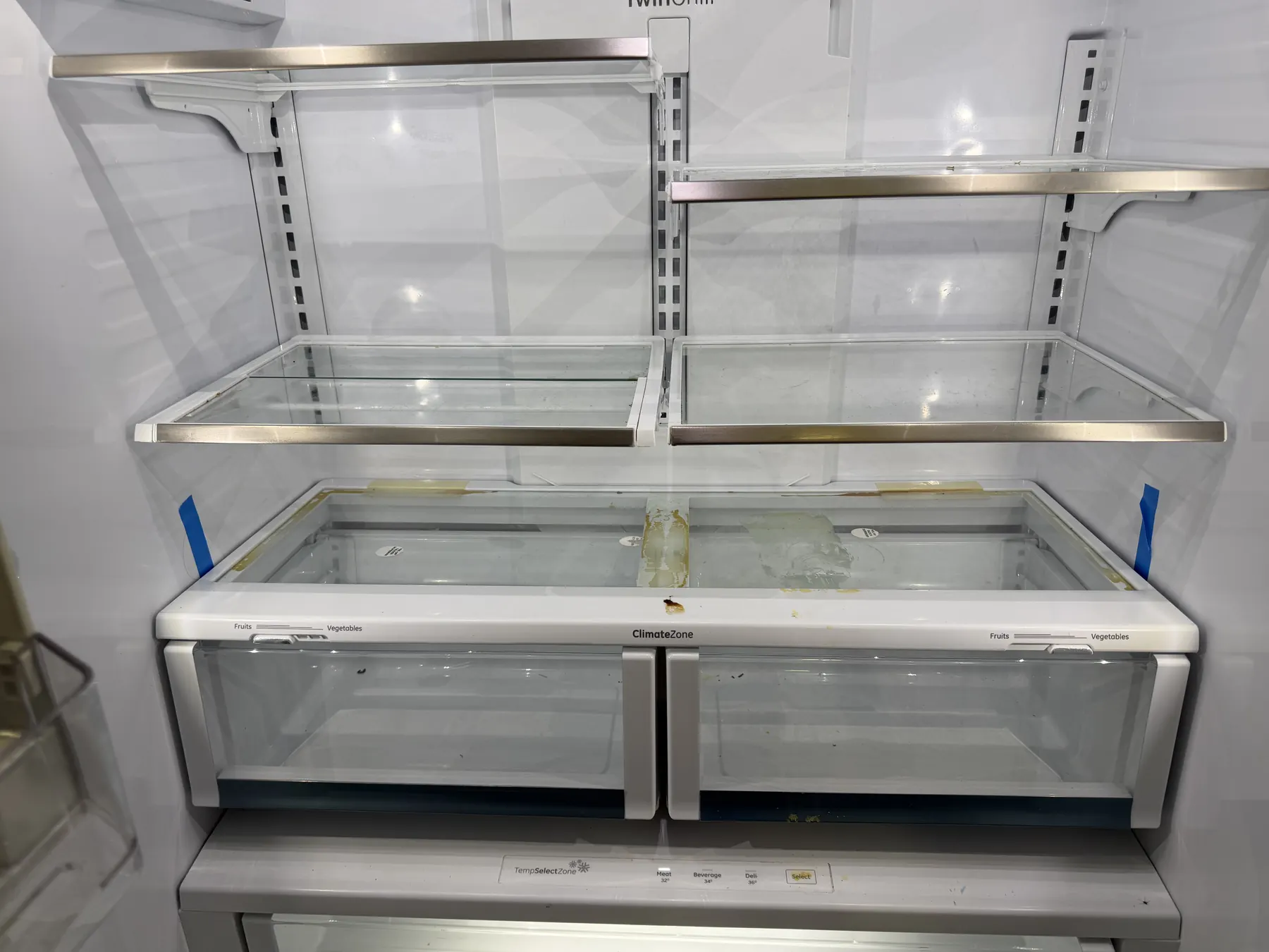 Client-provided before photo showing residue and marks inside a refrigerator