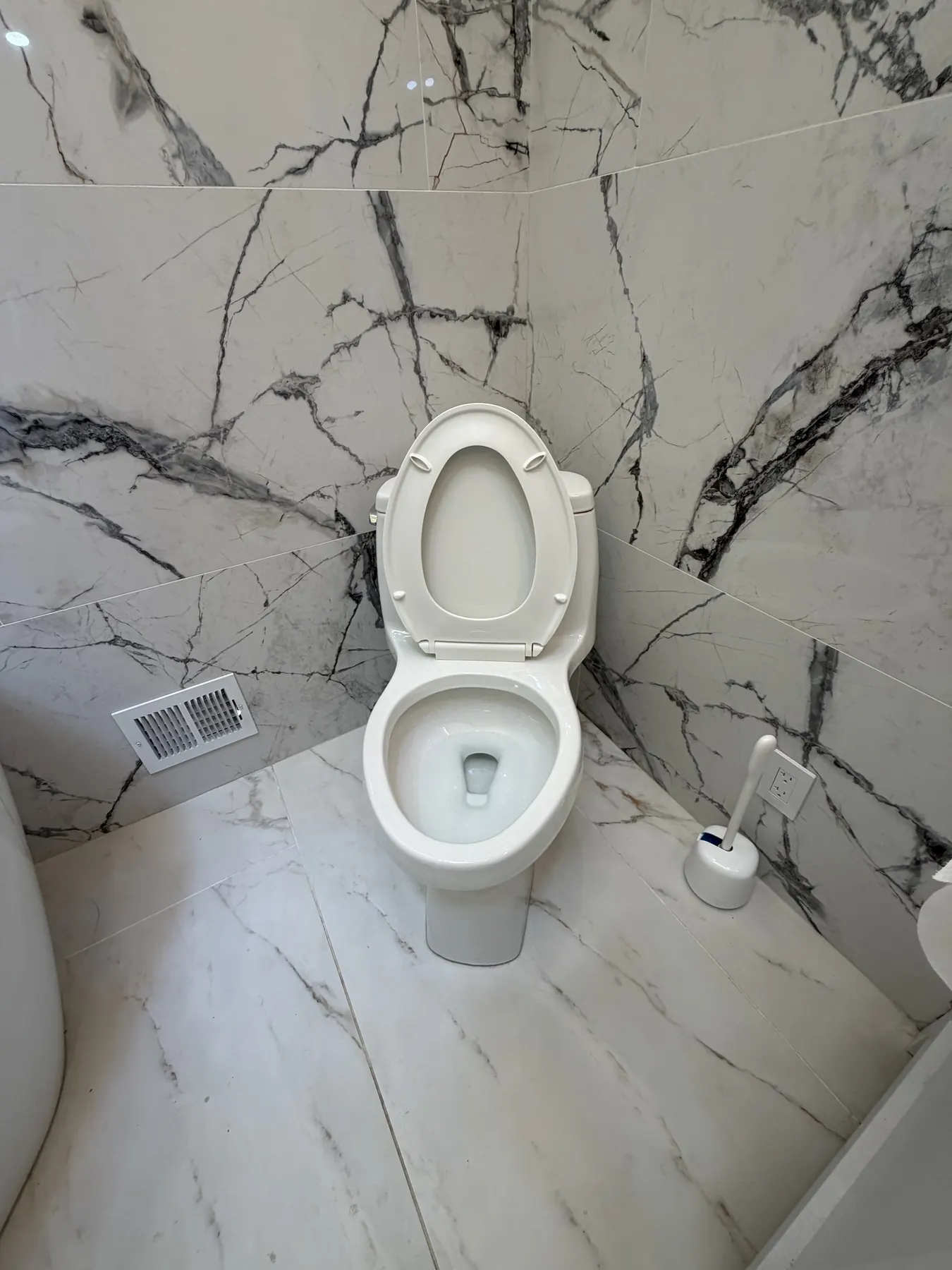 Client-provided after photo showing the cleaned toilet and surrounding floor